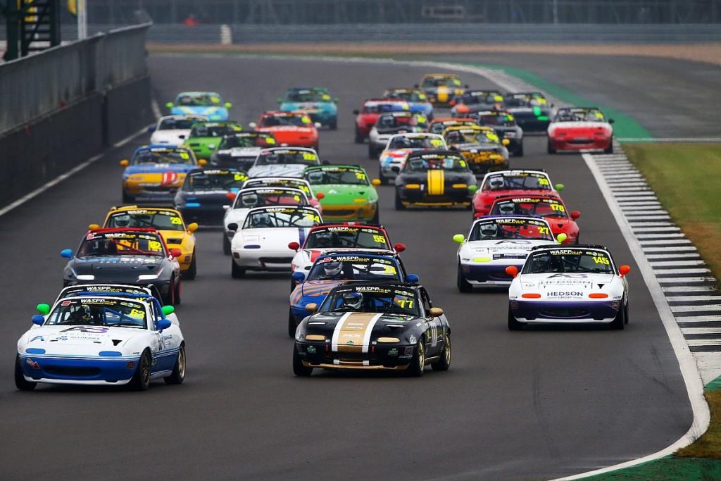 Mazda MX-5 race cars competing closely during a UK club motorsport meeting